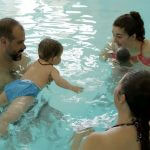 Une femme profite de la séance de bébés nageurs dans l'eau